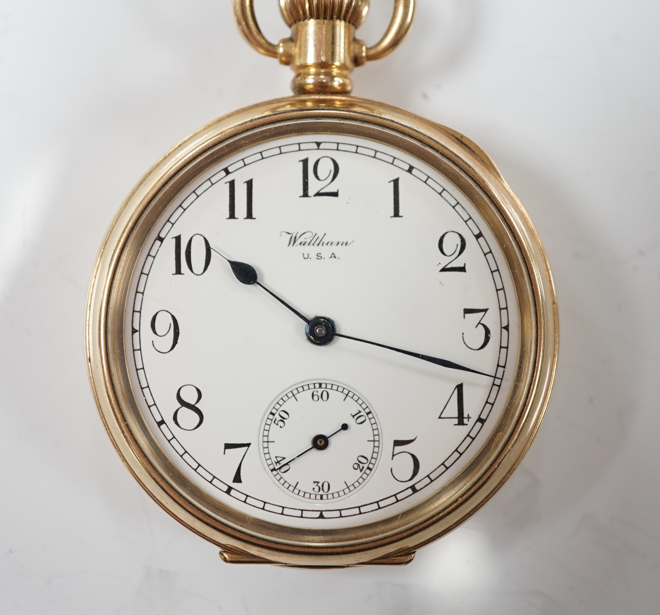 A Waltham gold plated open face keyless pocket watch, with Roman dial and subsidiary seconds.